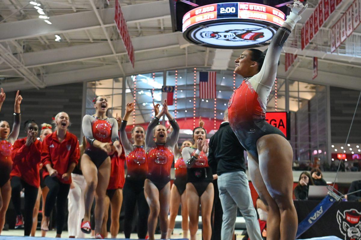 Graduate Alexis Ortega lands her jump off of the uneven bars during the meet against Clemson in Reynolds Coliseum on Saturday, Feb. 17, 2024. Ortega averaged 9.850 on her uneven bars routine. NC State beat Clemson 197.575-196.000.