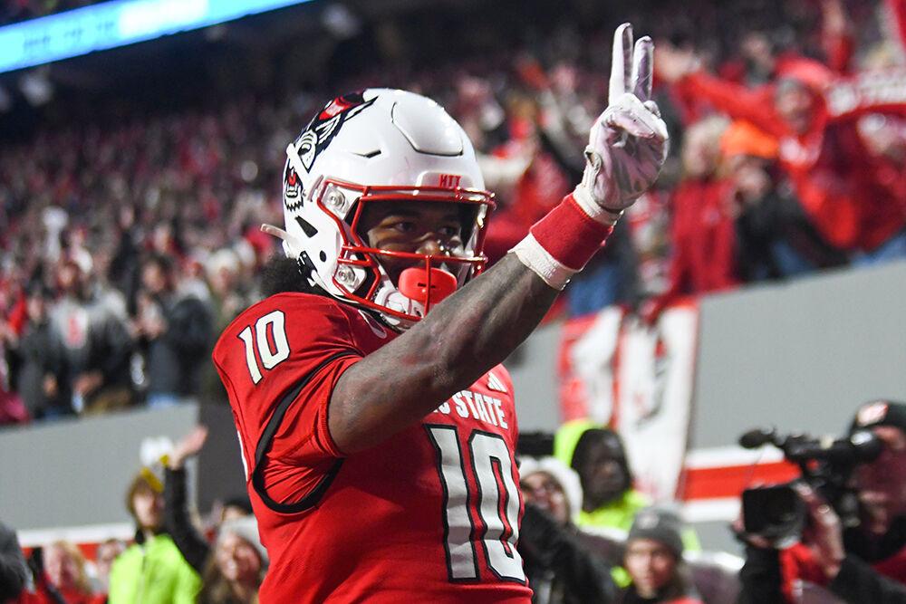Freshman wide receiver Kevin Concepcion holds up two fingers to signify his second touchdown in the game against UNC-Chapel Hill at Carter-Finley Stadium on Saturday, Nov. 25, 2023. NC State won the game 39-20.