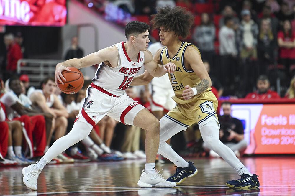 Graduate guard Michael O'Connell keeps the ball away from his opponent during the basketball game against Georgia Tech in PNC Arena on Saturday, Feb. 3, 2024. O'Connell scored 7 points. NC State beat Georgia Tech 82-76.
