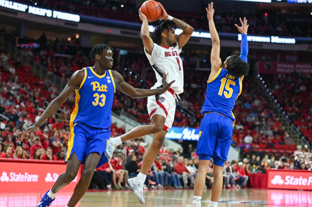 Junior guard Jayden Taylor is double-teamed by the Pittsburgh Panther offense in PNC Arena on Wednesday, Feb. 7, 2024. The Panthers beat the Wolfpack 67-64.