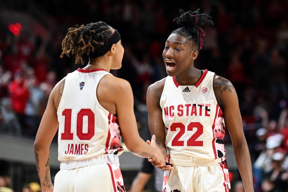 Junior guard Saniya Rivers shakes hands with junior guard Aziaha James and tells her that she's got her back after rebounding James' shot and scoring the basket to send the game into overtime during the game against Georgia Tech in Reynolds Coliseum on Sunday, Feb. 18, 2024. James and Rivers combined for 40 points. NC State beat Georgia Tech 86-85.