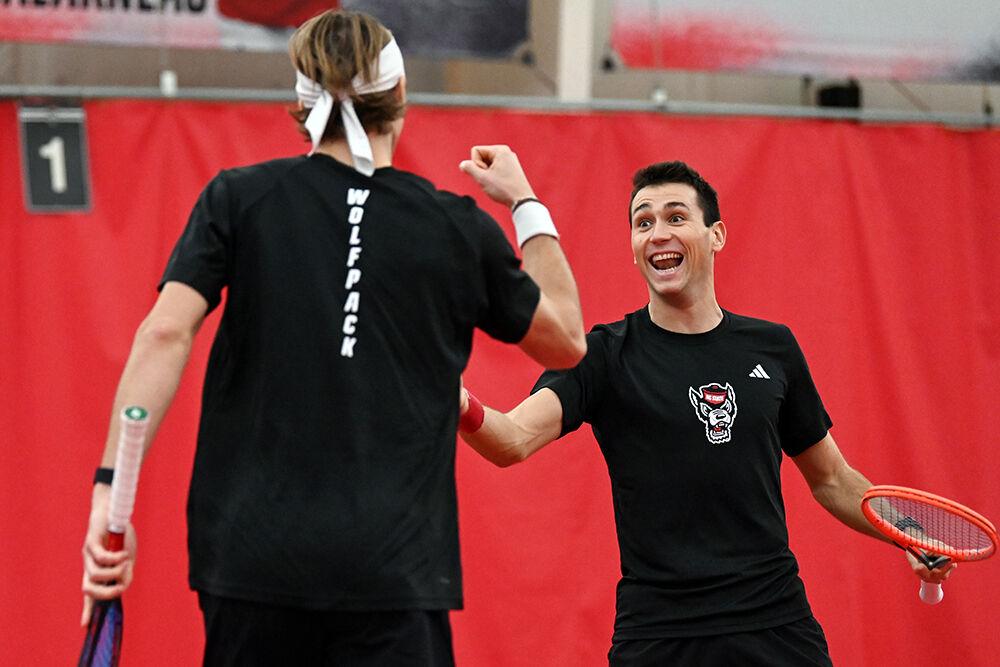 Senior Robin Catry and senior Luca Staeheli high-five after scoring a point during the match against Columbia at J.W. Isenhour Tennis Center on Sunday, Feb. 4, 2024. NC State lost to Columbia 4-3.