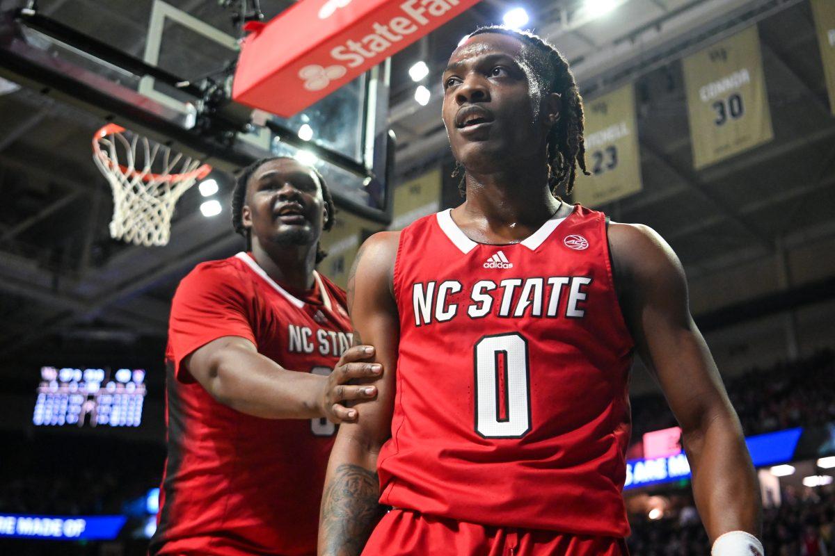 Graduate forward DJ Burns pulles graduate guard DJ Horne away from the Wake Forest players during the game in Lawrence Joel Veterans Memorial Coliseum on Saturday, Feb. 10, 2024. The scuffle occurred after Horne blocked a shot and flexed in celebration. NC State lost to Wake Forest 83-79.