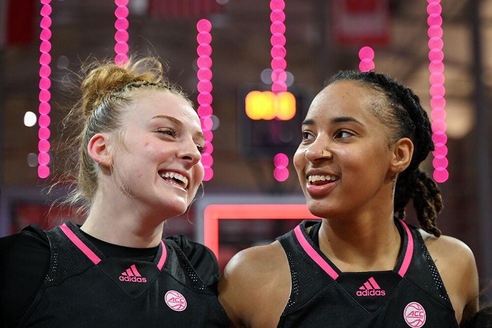 Freshman guard Laci Steele and junior guard Aziaha James laugh during the playing of the alma mater after the game against Louisville in Reynolds Coliseum on Monday, Feb. 5, 2024. NC State beat Louisville 77-67.