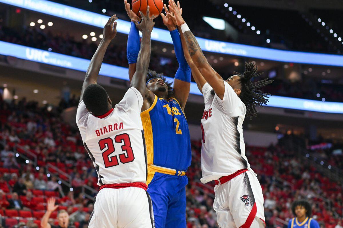 Junior forward Mohamed Diarra and junior guard Jayden Taylor double-team the Pittsburgh Panther offense in PNC Arena on Wednesday, Feb. 7, 2024. The Panthers beat the Wolfpack 67-64.