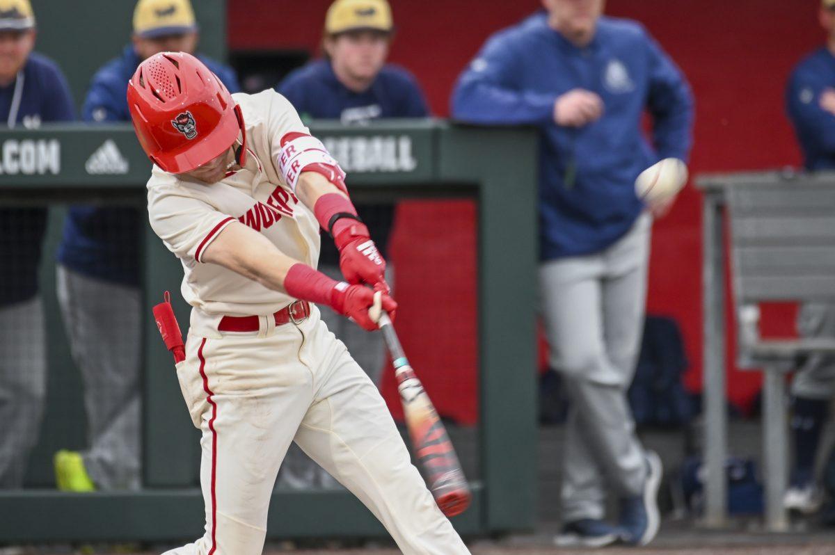 Junior infielder Brandon Butterworth hits the ball during the baseball game against Queens University at Doak Field at Dail Park on Wednesday, Feb. 28, 2024. Butterworth scored one run. NC State beat Queens 17-2.