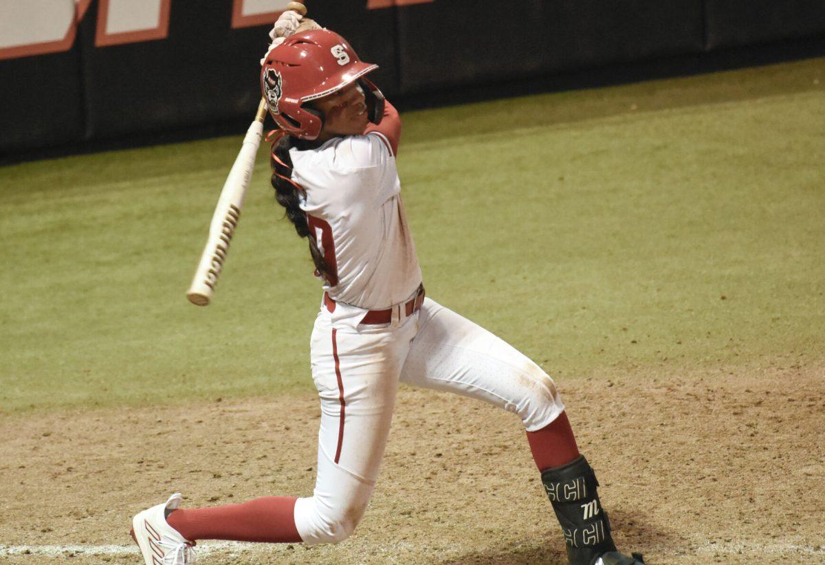 Sophomore shortstop MaKayla Marbury swings and slams the ball during the game against Campbell at Dail Softball Stadium on Friday, Feb. 16, 2024. Marbury had a triple base hit with the swing. NC State beat Campbell 4-3.
