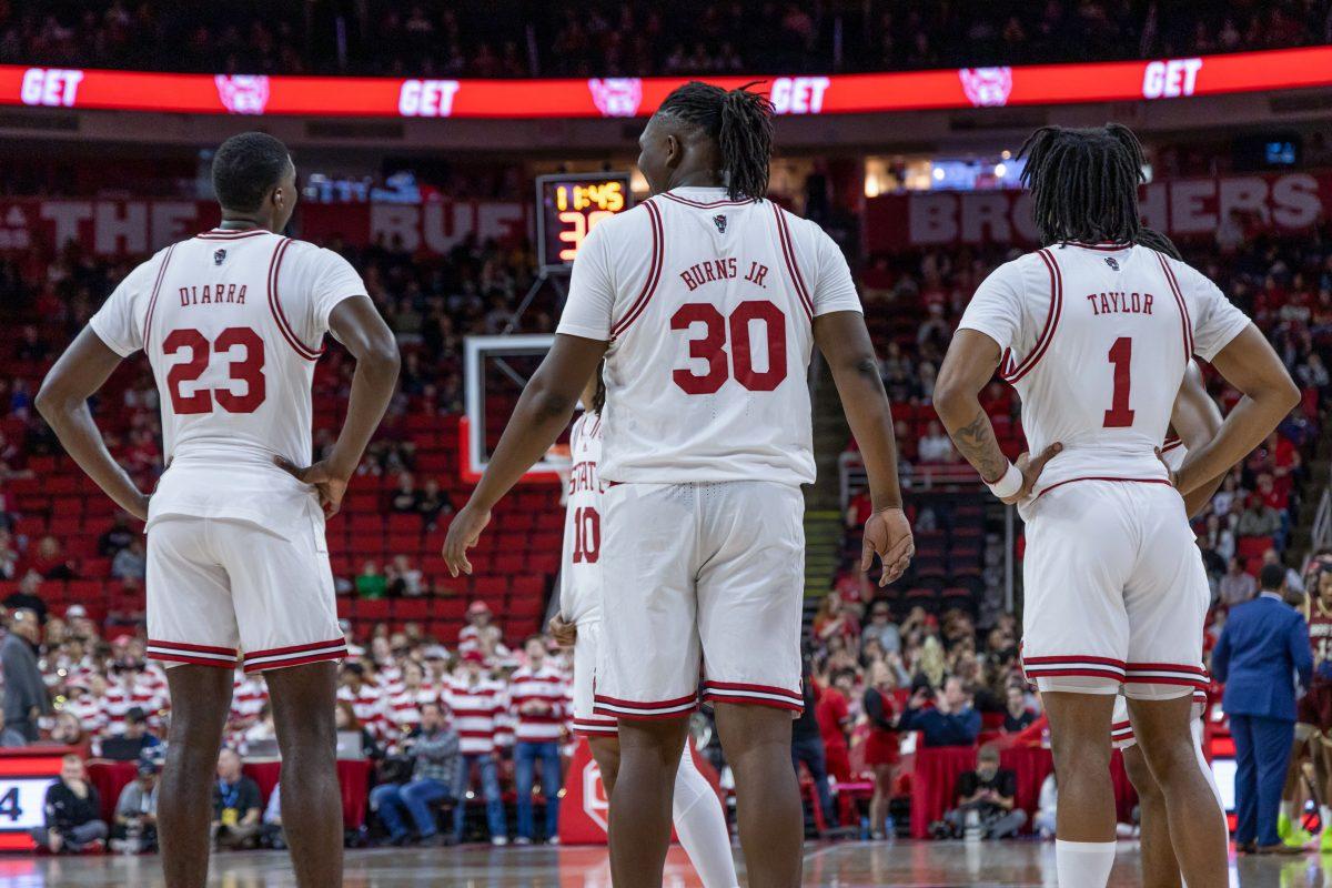 Junior forward Mohamed Diarra (left), graduate forward DJ Burns Jr. (middle) and junior guard Jayden Taylor (right) wait for their opponents during the game against Boston College in PNC Arena on Saturday, Feb. 24, 2024. The three scored a combined 42 points during the game. NC State beat Boston College 81-70.