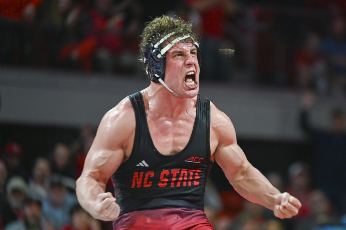 Redshirt senior Trent Hidlay celebrates winning his duel during the wrestling match at Reynolds Coliseum on Sunday, Feb. 23, 2024. The duel marked Hidlay's 1,000th career win. NC State beat Virginia Tech 20-12.