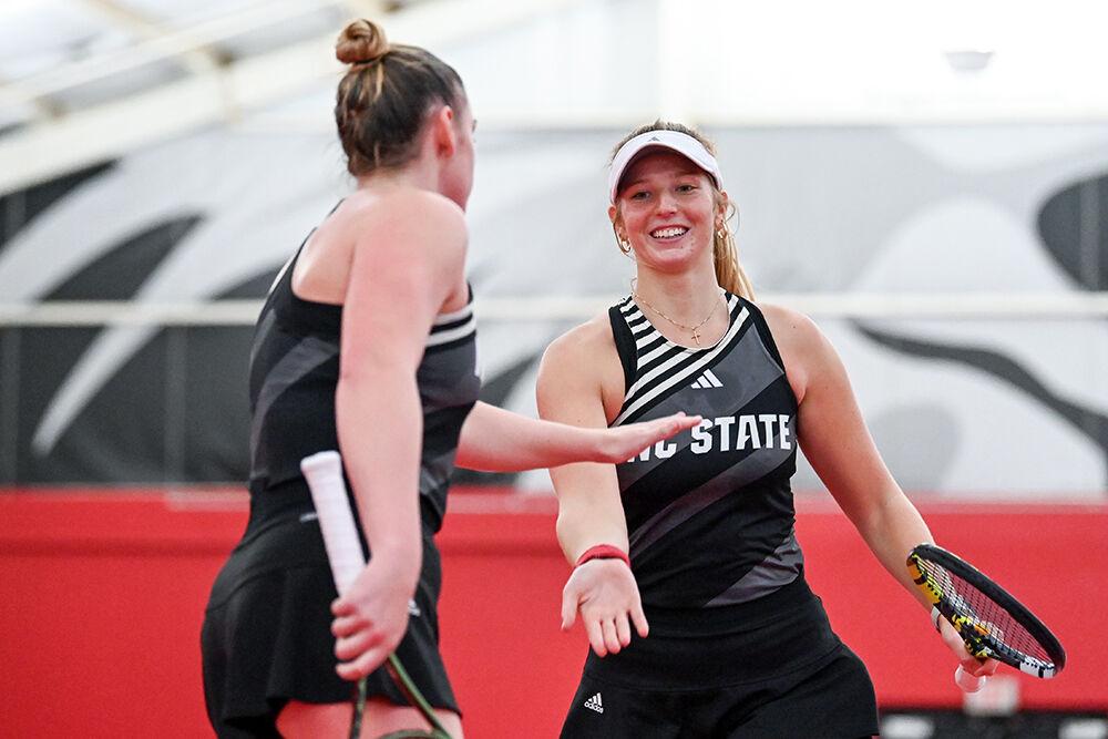 Freshman Maddy Zampardo high-fives senior Amelia Rajecki after winning the doubles match against Clemson at J.W. Isenhour Tennis Center on Sunday, Jan. 28, 2024. Zampardo and Rajecki won the doubles match 6-2. NC State beat Clemson 4-0.