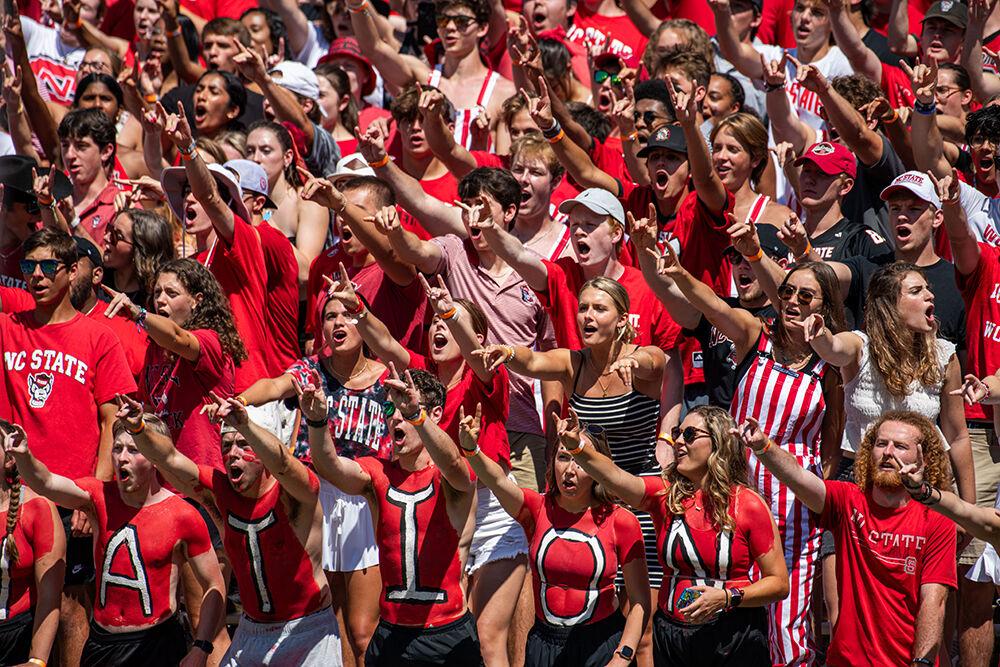 Students throw up wolfies and chant wolfpack during the game against VMI at Carter-Fiinley Stadium on Sept. 16, 2023. NC State beat VMI 45-7.