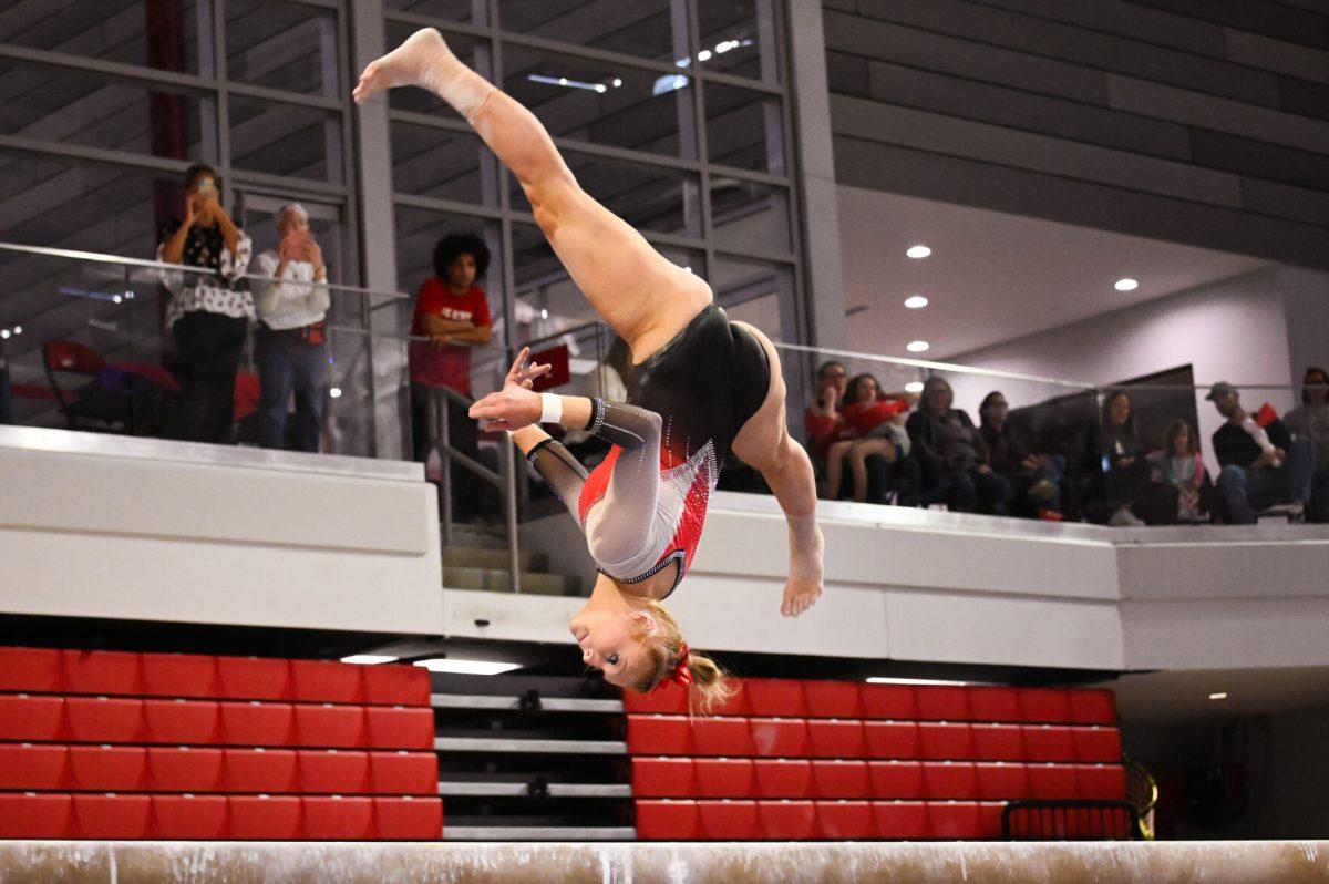 Senior Krista Zultevicz flips into a split on the balance beam during the meet against Clemson in Reynolds Coliseum on Saturday, Feb. 17, 2024. NC State beat Clemson 197.575-196.000.