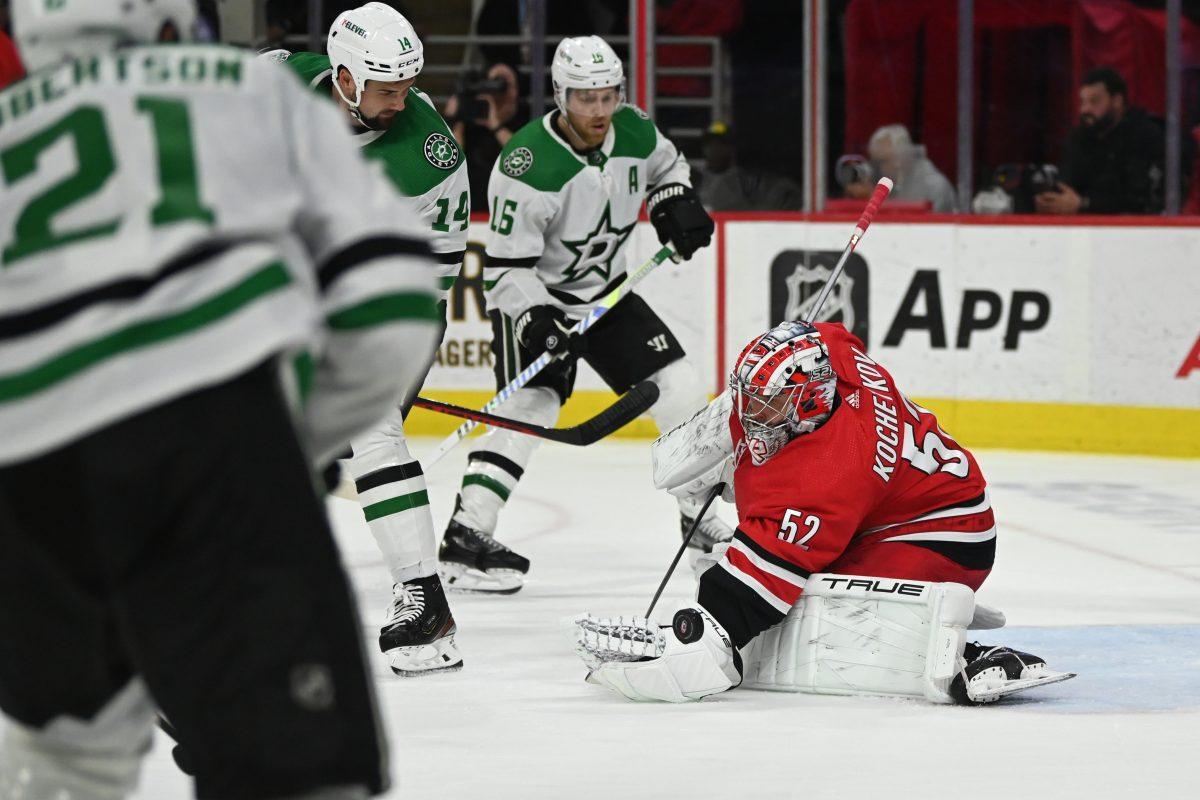 Carolina goaltender Pyotr Kochetkov attempts to cover the puck during the Hurricanes&#8217; home game against the Dallas Stars in PNC Arena on Saturday, Feb. 24, 2024. Kochetkov faced 16 shots and gave up two goals for a .875 SV%. The Stars beat the Canes 2-1.