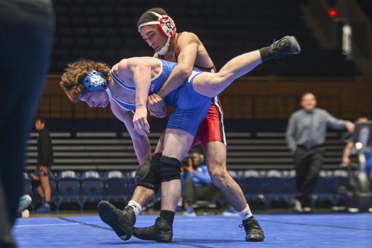 Freshman Tyler Tracy lifts his opponent during the wrestling match at Cameron Indoor Stadium on Sunday, Feb. 18, 2024. Tracy won the 141 bout 11-0. NC State beat Duke 36-9.