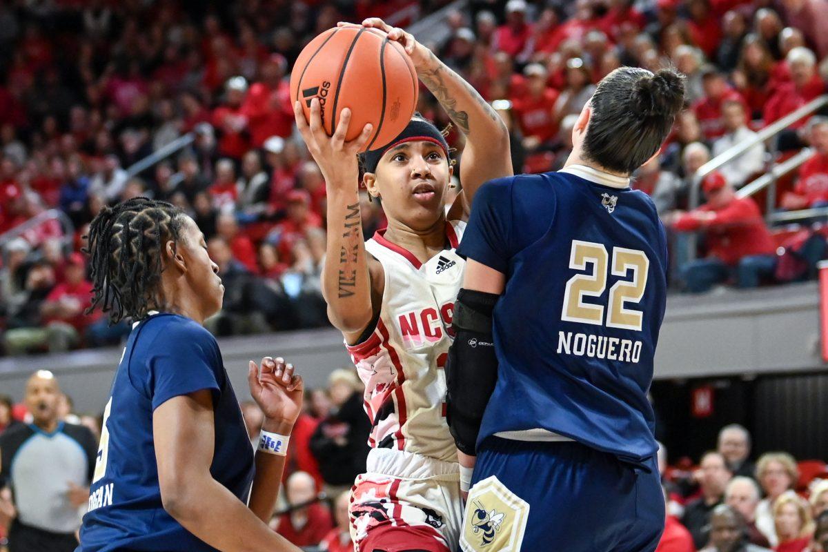 Junior guard Aziaha James shoots the ball between the defense during the game against Georgia Tech in Reynolds Coliseum on Sunday, Feb. 18, 2024. James led in scoring with 30 points. NC State beat Georgia Tech 86-85 in overtime.