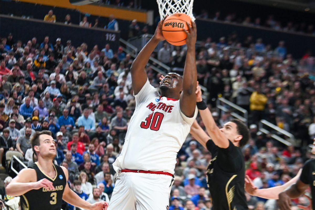 Graduate forward DJ Burns makes a layup during the NCAA March Madness round two game against the Oakland University Golden Grizzlies in PPG Paints Arena on Saturday, March 23, 2024. Burns had 24 points. The Wolfpack beat the Golden Grizzlies 79-73 in overtime.