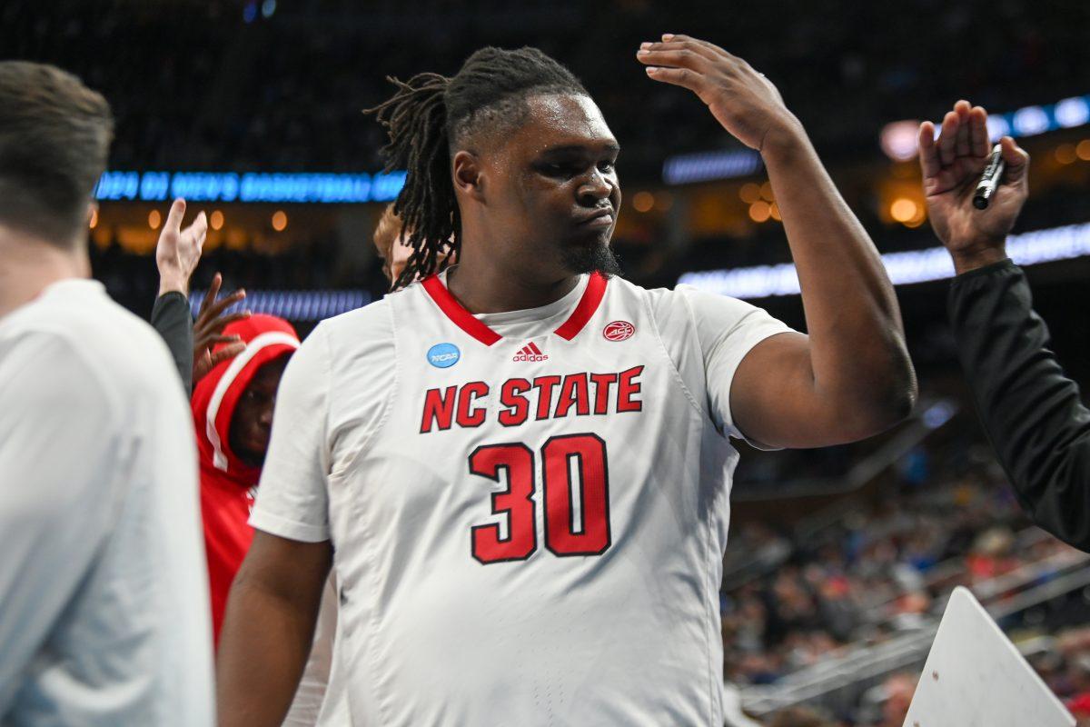 Graduate forward DJ Burns gets hyped with a coach prior to the NCAA March Madness round two game against the Oakland University Golden Grizzlies in PPG Paints Arena on Saturday, March 23, 2024. Burns had 24 points and 11 rebounds. The Wolfpack beat the Golden Grizzlies 79-73 in overtime.