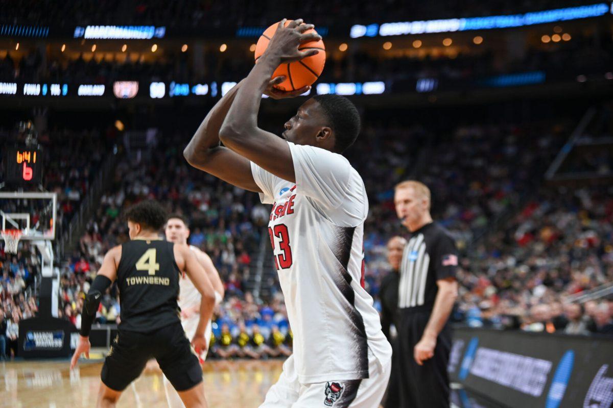 Junior forward Mohamed Diarra shoots a three-point shot during the NCAA March Madness round two game against the Oakland University Golden Grizzlies in PPG Paints Arena on Saturday, March 23, 2024. Diarra had 12 rebounds. The Wolfpack beat the Golden Grizzlies 79-73 in overtime.