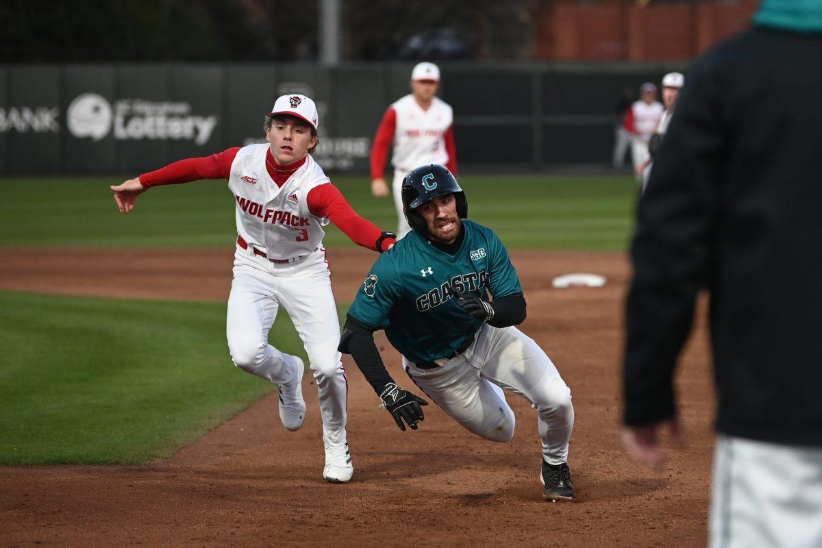 Junior infielder Brandon Butterworth tags out a Coastal Carolina player caught in a pickle during the Wolfpack's home game against the Coastal Carolina Chanticleers on Doak Field at Dail Park on Tuesday, March 19, 2024. The Wolfpack beat the Chanticleers 9-8.