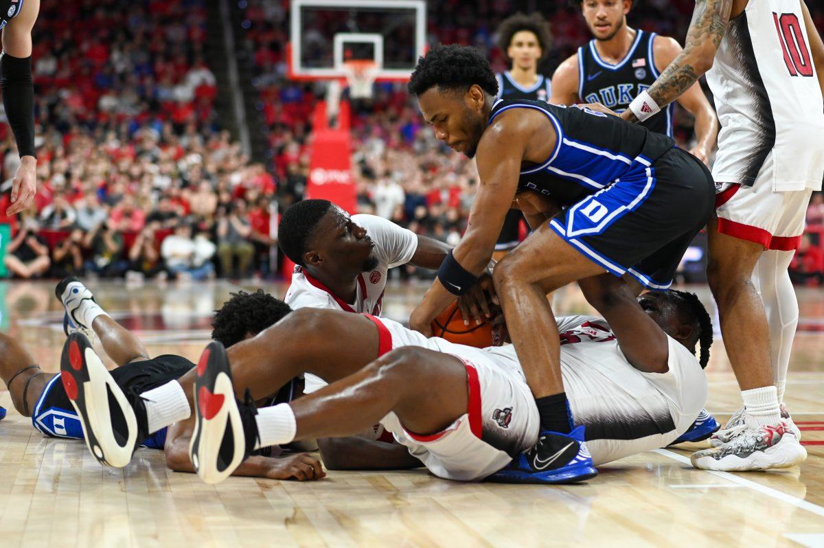 NC State and Duke players battle for possession of a loose ball in PNC Arena on Monday, March 4, 2024. The Wolfpack lost to the Blue Devils 79-64.