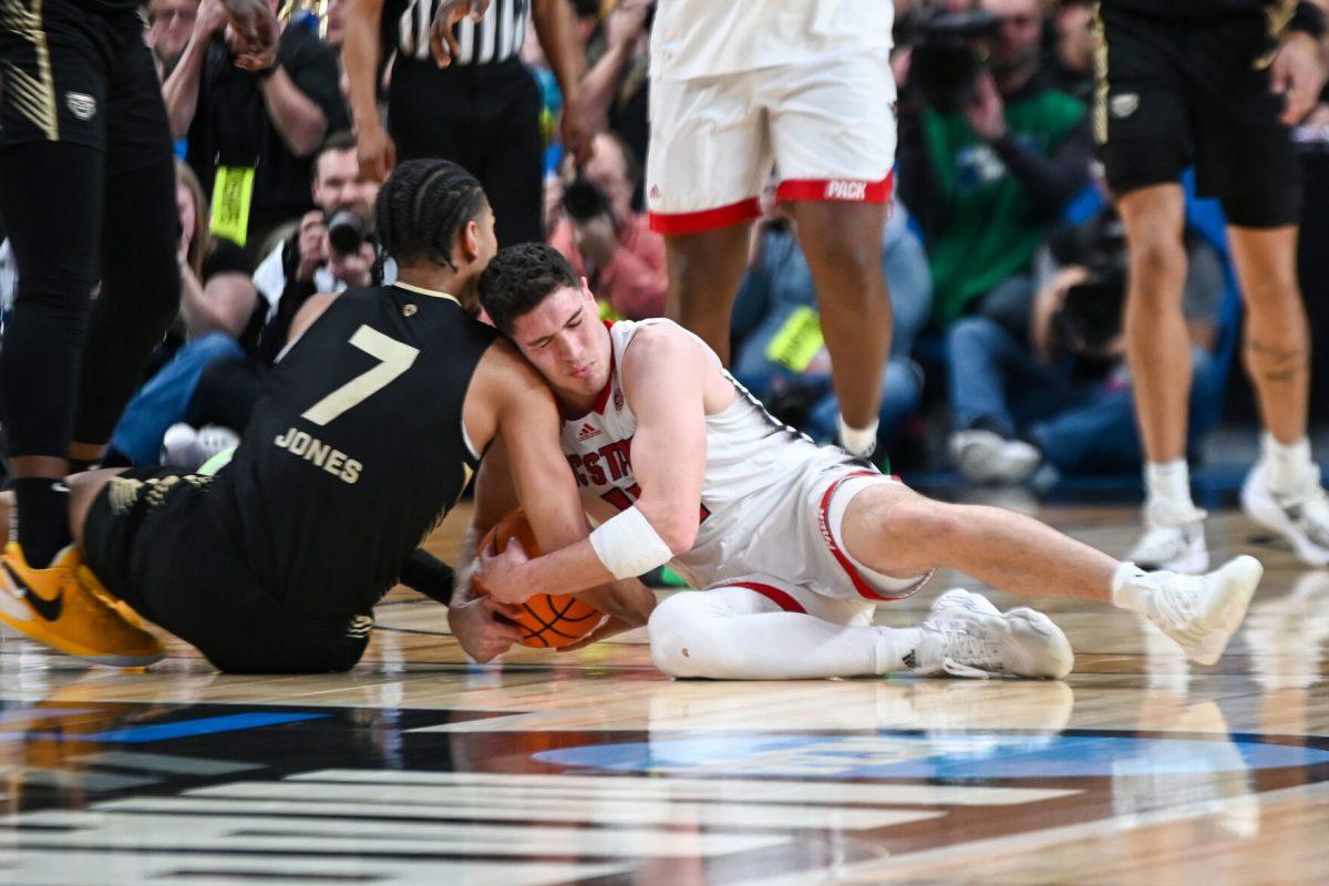 Graduate guard Michael O'Connell fights for a loose ball during the NCAA March Madness round two game against the Oakland University Golden Grizzlies in PPG Paints Arena on Saturday, March 23, 2024. O'Connell had 12 points. The Wolfpack beat the Golden Grizzlies 79-73 in overtime.