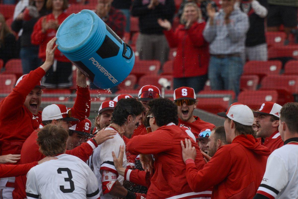 Teammates pour water on sophomore infielder/outfielder Eli Serrano after winning the game against Duke at Doak Field at Dail Park on Saturday, March 23, 2024. Serrano III scored a walk-off home run in the 9th inning that shifted the score in NC State's favor. The Wolfpack defeated the Blue Devils 9-8.