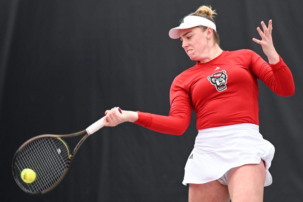 Senior Amelia Rajecki returns the ball during the match against Notre Dame at Dail Outdoor Tennis Stadium on Friday, March 1, 2024. Rajecki won both her doubles and singles matches. NC State beat Notre Dame 5-2.