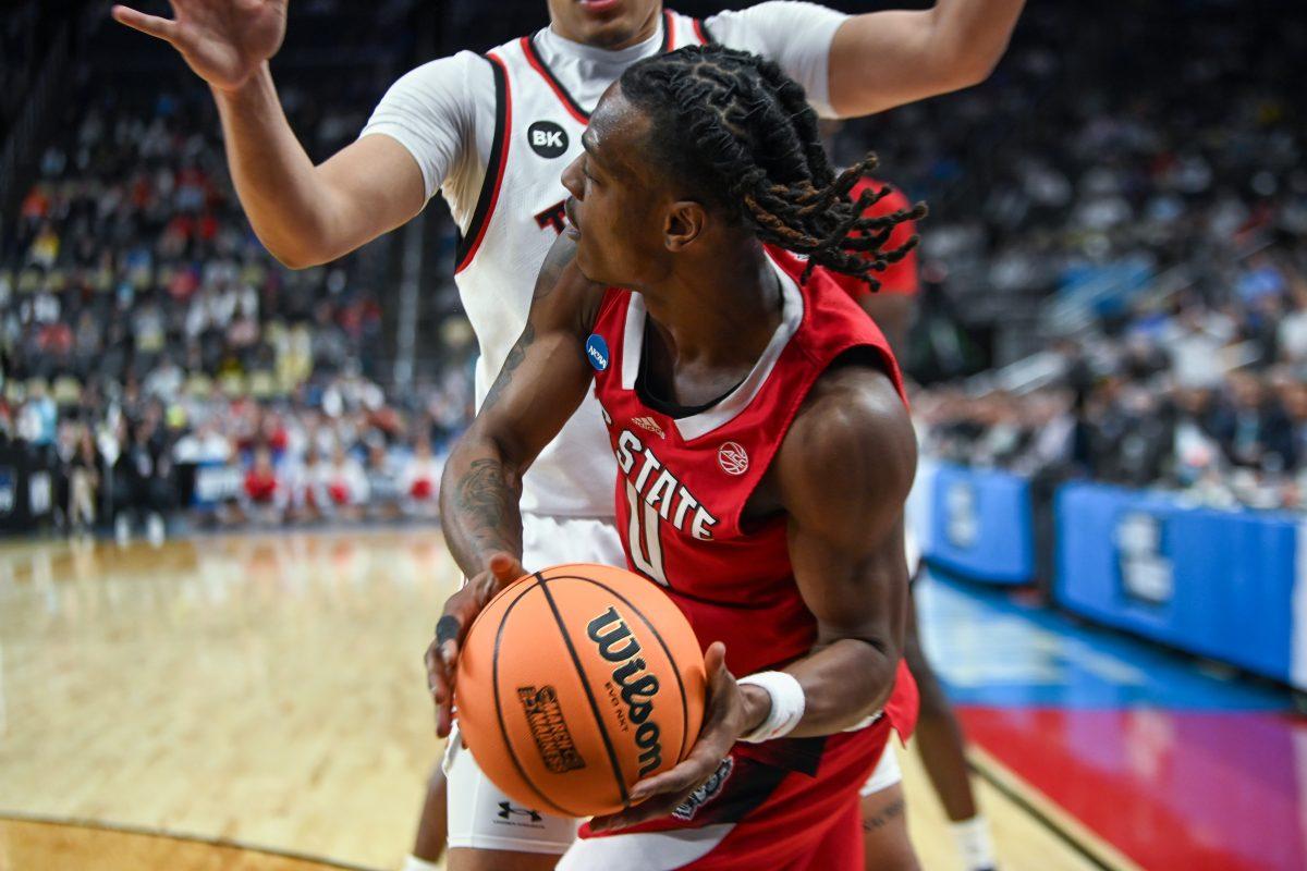 Graduate Guard DJ Horne looks for a pass during the NCAA March Madness first round game against the Texas Tech Red Raiders in PPG Paints Arena on Thursday, March 21, 2024. Horne had one steal during the game. NC State beat Texas Tech 80-67.