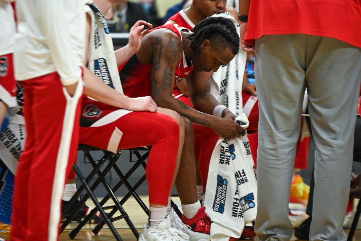Graduate Guard DJ Horne rests during a timeout during the NCAA March Madness first round game against the Texas Tech Red Raiders in PPG Paints Arena on Thursday, March 21, 2024. Horne had 16 points during the game. NC State beat Texas Tech 80-67.