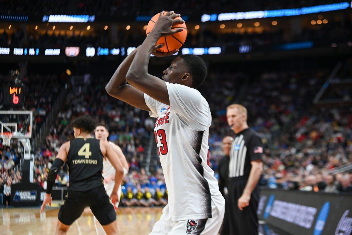 Junior forward Mohamed Diarra shoots a three-point shot during the NCAA March Madness round two game against the Oakland University Golden Grizzlies in PPG Paints Arena on Saturday, March 23, 2024. Diarra had 12 rebounds. The Wolfpack beat the Golden Grizzlies 79-73 in overtime.