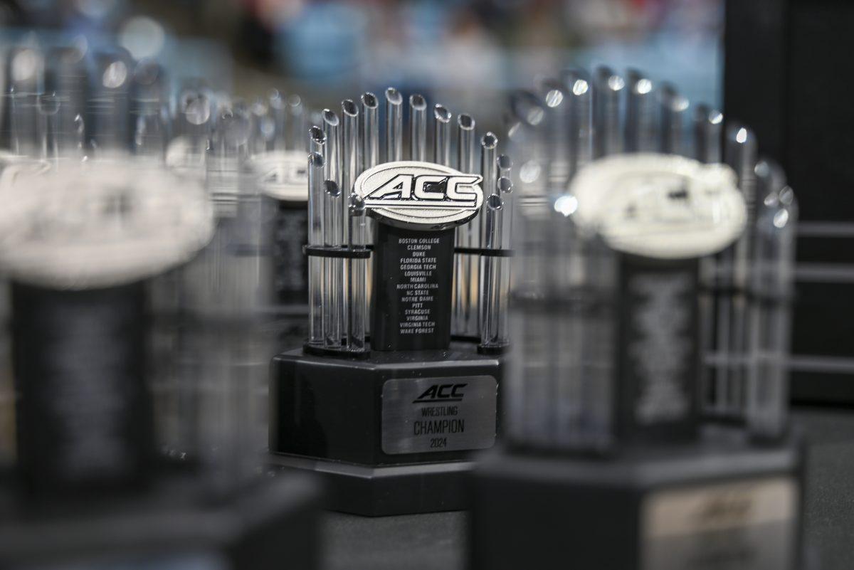 Miniature versions of the 2024 ACC Wrestling Championship trophy sits on a display table during the 2024 ACC Wrestling Championship in Carmichael Arena on Sunday, March 10, 2024.