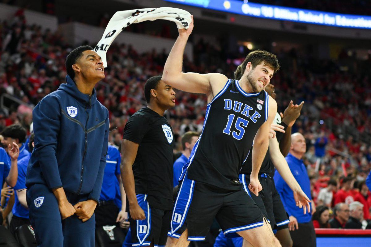 Duke graduate center Ryan Young celebrates with the rest of the Duke Blue Devil bench in the second half of the game versus the NC State Wolfpack in PNC Arena on Monday, March 4, 2024. The Wolfpack lost to the Blue Devils 79-64.