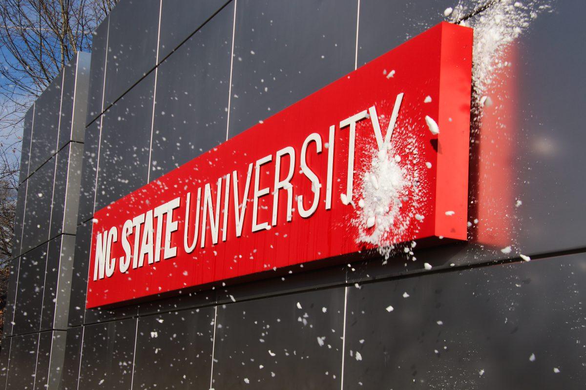 In this archive photo taken on Jan. 23, 2022, a snowball is thrown at the NC State University sign on Western Blvd. The snow storm started the previous Friday.