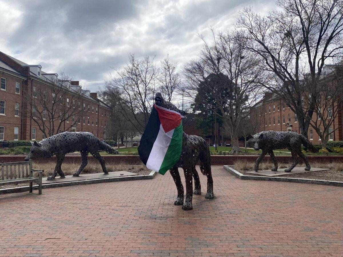 A Palestinian flag hangs from a statue in Wolf Plaza after a protest on Monday, March 4. NC State's Arab Student Organization and Students for Justice in Palestine organized the pro-Palestine protest, which began in Wolf Plaza.