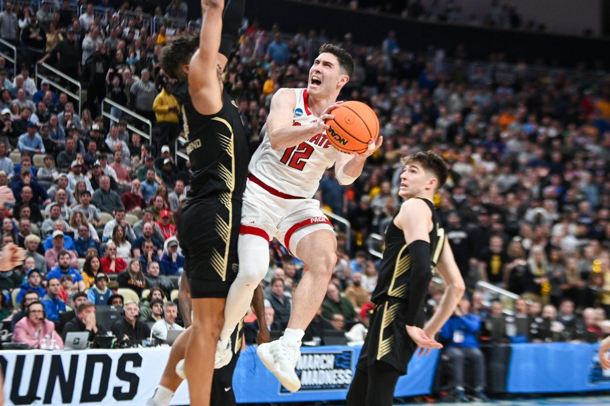 Graduate guard Michael O'Connell goes for a layup and draws a penalty during the NCAA March Madness round two game against the Oakland University Golden Grizzlies in PPG Paints Arena on Saturday, March 23, 2024. O'Connell had 12 rebounds. The Wolfpack beat the Golden Grizzlies 79-73 in overtime.
