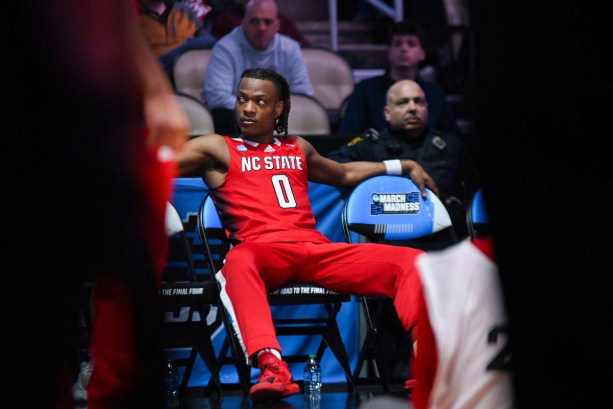 Graduate guard DJ Horne sits on the bench during team introductions before the NCAA March Madness first round game against the Texas Tech Red Raiders in PPG Paints Arena on Thursday, March 21, 2024. Horne had 16 points during the game. NC State beat Texas Tech 80-67.