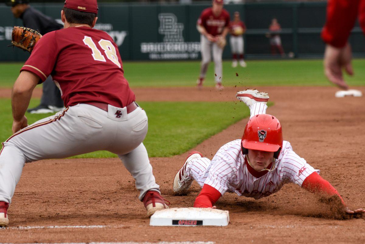 Junior outfielder Chase Nixon dives headfirst into first base during the game against Boston College in Doak Field at Dail Park on Friday, March 8, 2024. The Wolfpack defeated the Eagles 5-4 (11).