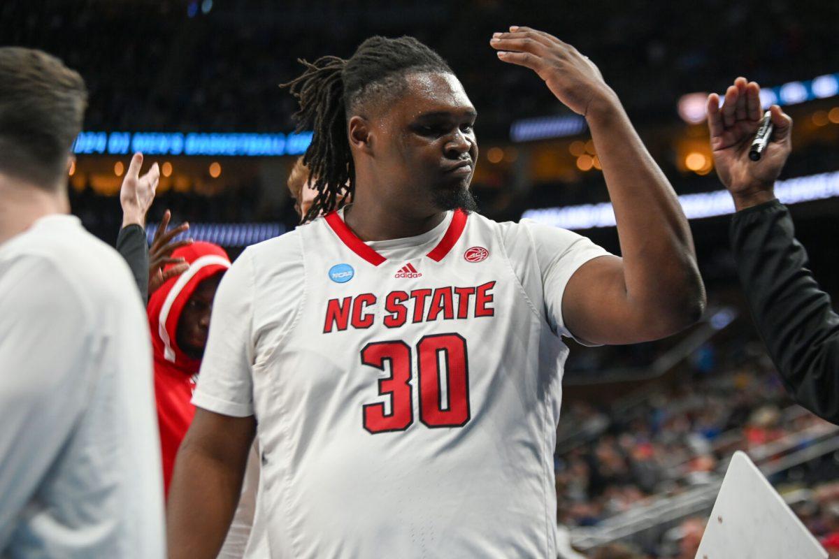 Graduate forward DJ Burns gets hyped with a coach prior to the NCAA March Madness round two game against the Oakland University Golden Grizzlies in PPG Paints Arena on Saturday, March 23, 2024. Burns had 24 points and 11 rebounds. The Wolfpack beat the Golden Grizzlies 79-73 in overtime.