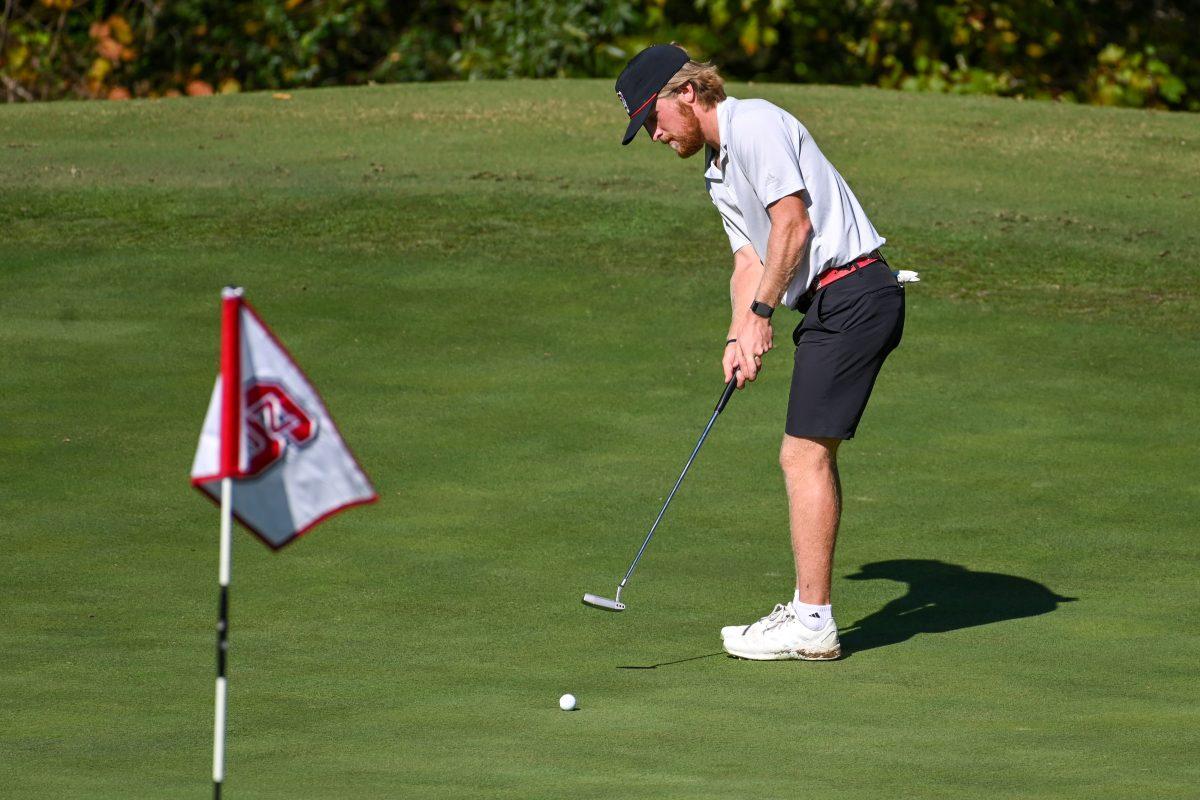 Senior Carter Graf putts the ball during the Wolfpack Intercollegiate tournament on Saturday, Oct. 15, 2022 at Lonnie Poole Golf Course. Graf had a score of 1-under. NC State tied for second place.