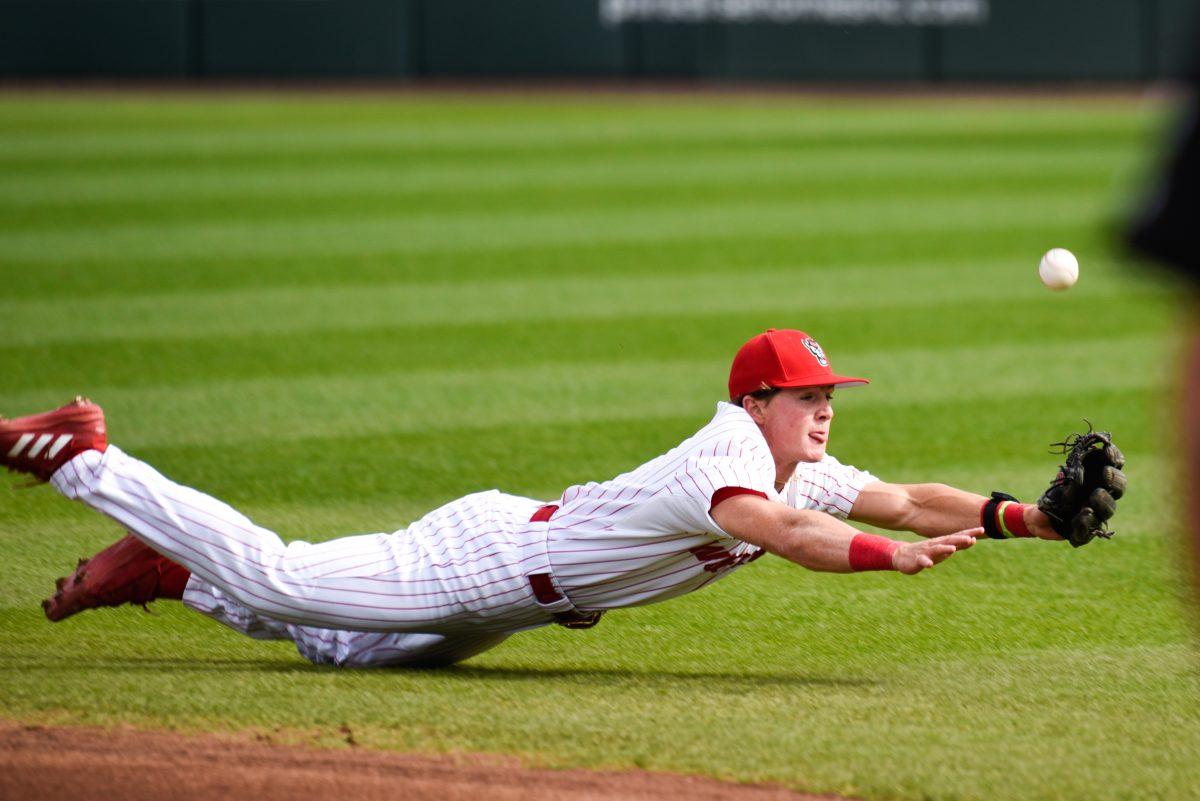 Freshman infielder Luke Nixon dives for the ball during the game against Boston College in Doak Field at Dail Park on Friday, March 8, 2024. The Wolfpack defeated the Eagles 5-4 (11).