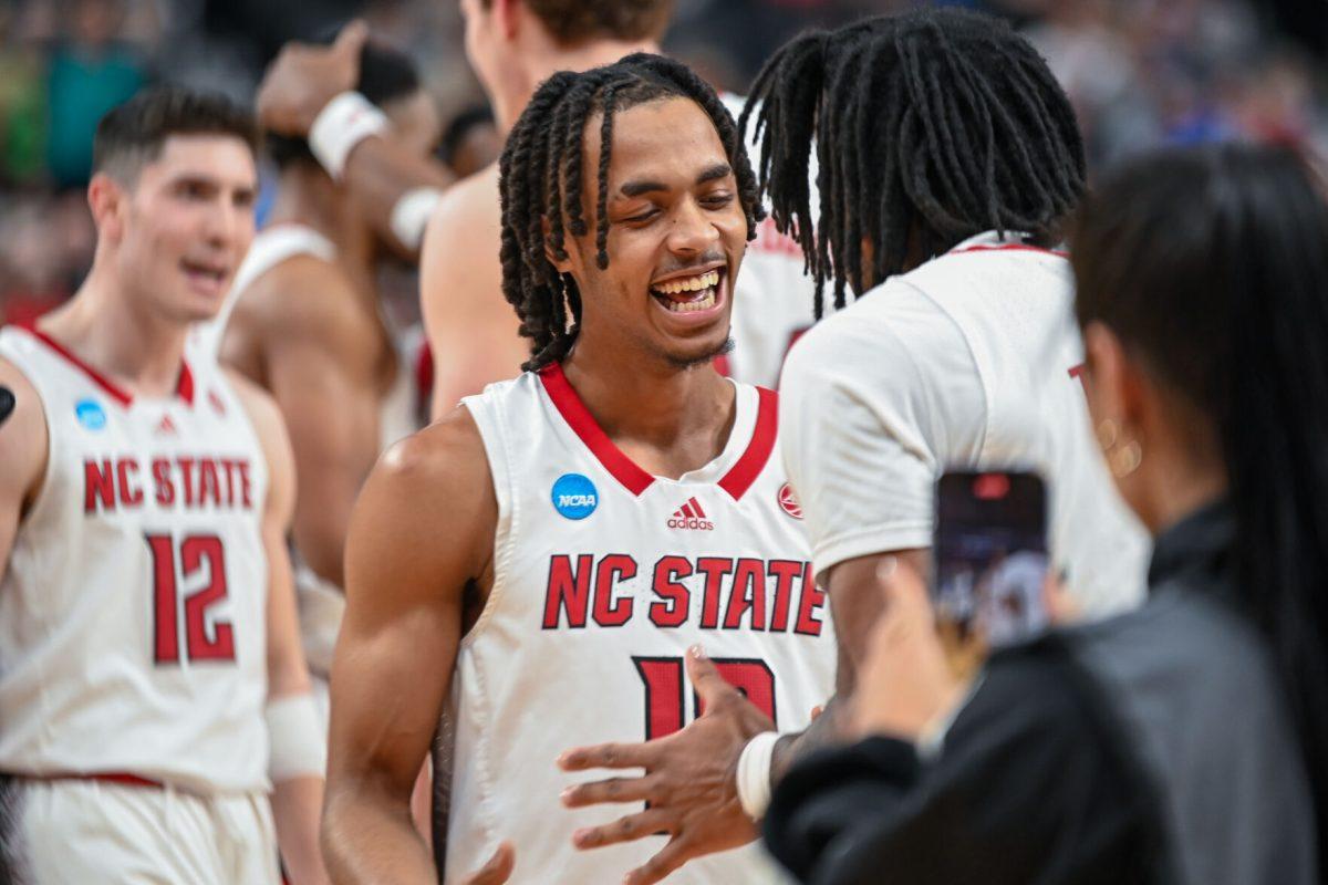 Junior guard Breon Pass congratulates a teammate during the NCAA March Madness round two game against the Oakland University Golden Grizzlies in PPG Paints Arena on Saturday, March 23, 2024. The Wolfpack beat the Golden Grizzlies 79-73 in overtime.