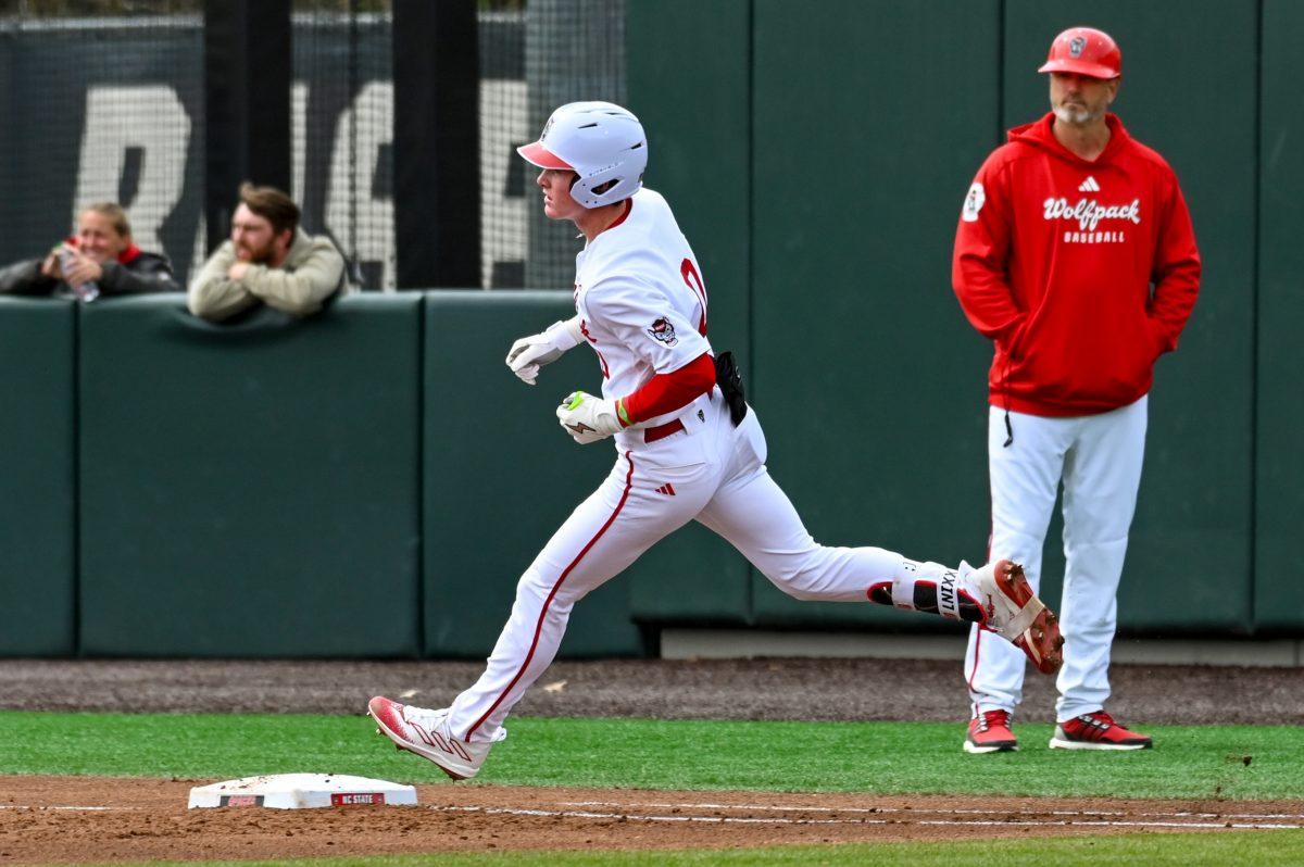 Freshman infielder Luke Nixon rounds first base during the baseball game against Towson at Doak Field at Dail Park on Friday, March 1, 2024. NC State beat Towson 6-5.