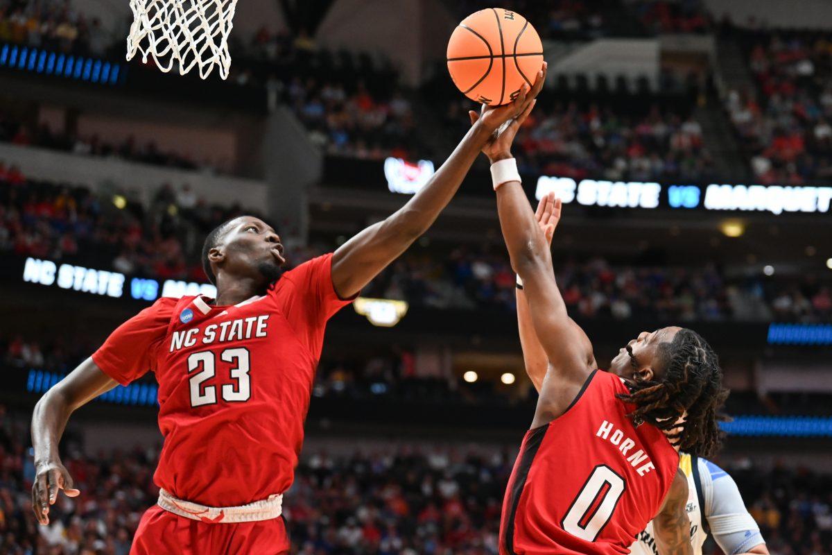 Junior forward Mohamed Diarra and graduate guard DJ Horne grab the rebound during the Sweet 16 game of the NCAA Tournament against Marquette at American Airlines&#160;Center in Dallas on Friday, March 29, 2024. NC State beat Marquette 67-58.