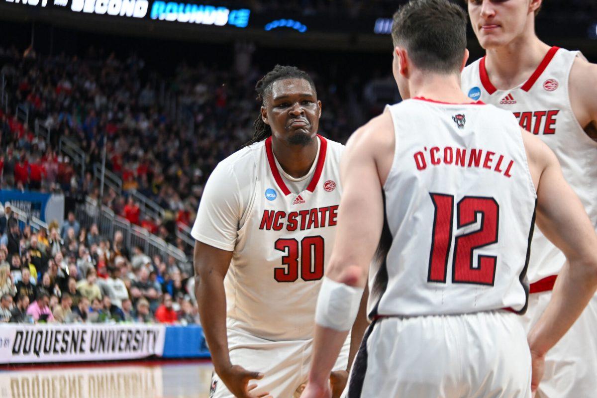 Graduate forward DJ Burns hypes up graduate guard Michael O'Connell during the NCAA March Madness round two game against the Oakland University Golden Grizzlies in PPG Paints Arena on Saturday, March 23, 2024.Burns had 11 rebounds. The Wolfpack beat the Golden Grizzlies 79-73 in overtime.