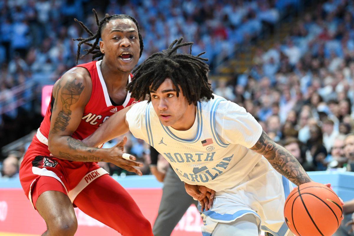 Graduate guard DJ Horne attempts to slow down his opponent during the game against UNC-Chapel Hill in Dean E. Smith Center on Saturday, March 2, 2024. Horne scored 20 points. NC State lost to Chapel Hill 79-70.