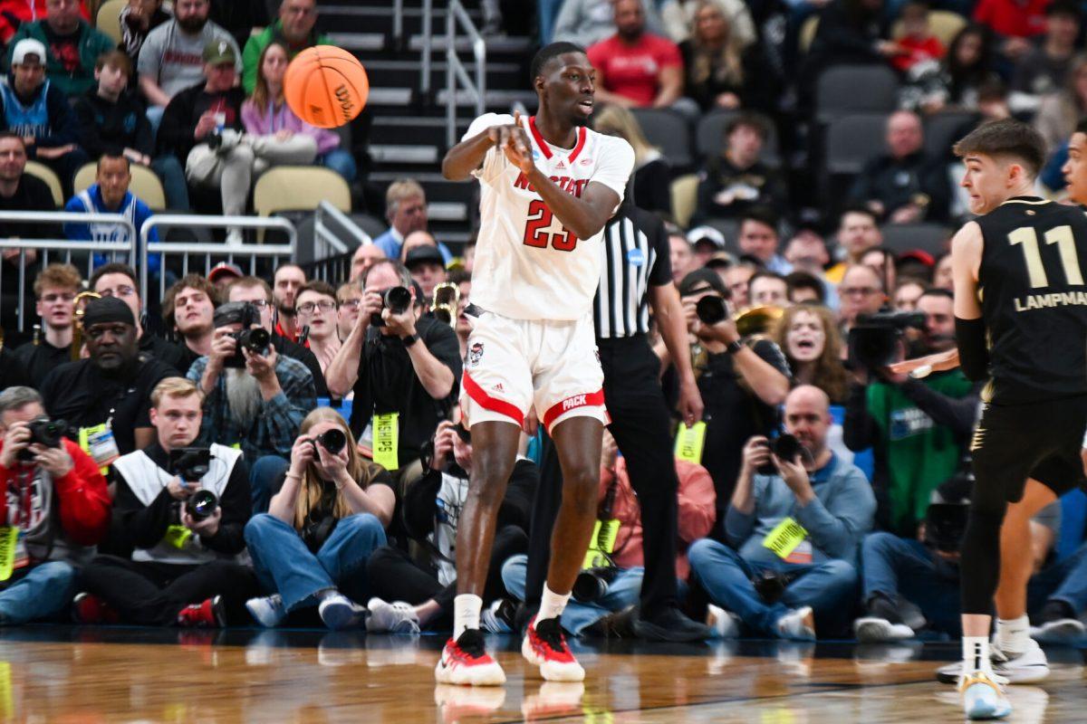 Junior forward Mohamed Diarra throws a no-look pass during the NCAA March Madness round two game against the Oakland University Golden Grizzlies in PPG Paints Arena on Saturday, March 23, 2024. Diarra had 13 rebounds. The Wolfpack beat the Golden Grizzlies 79-73 in overtime.