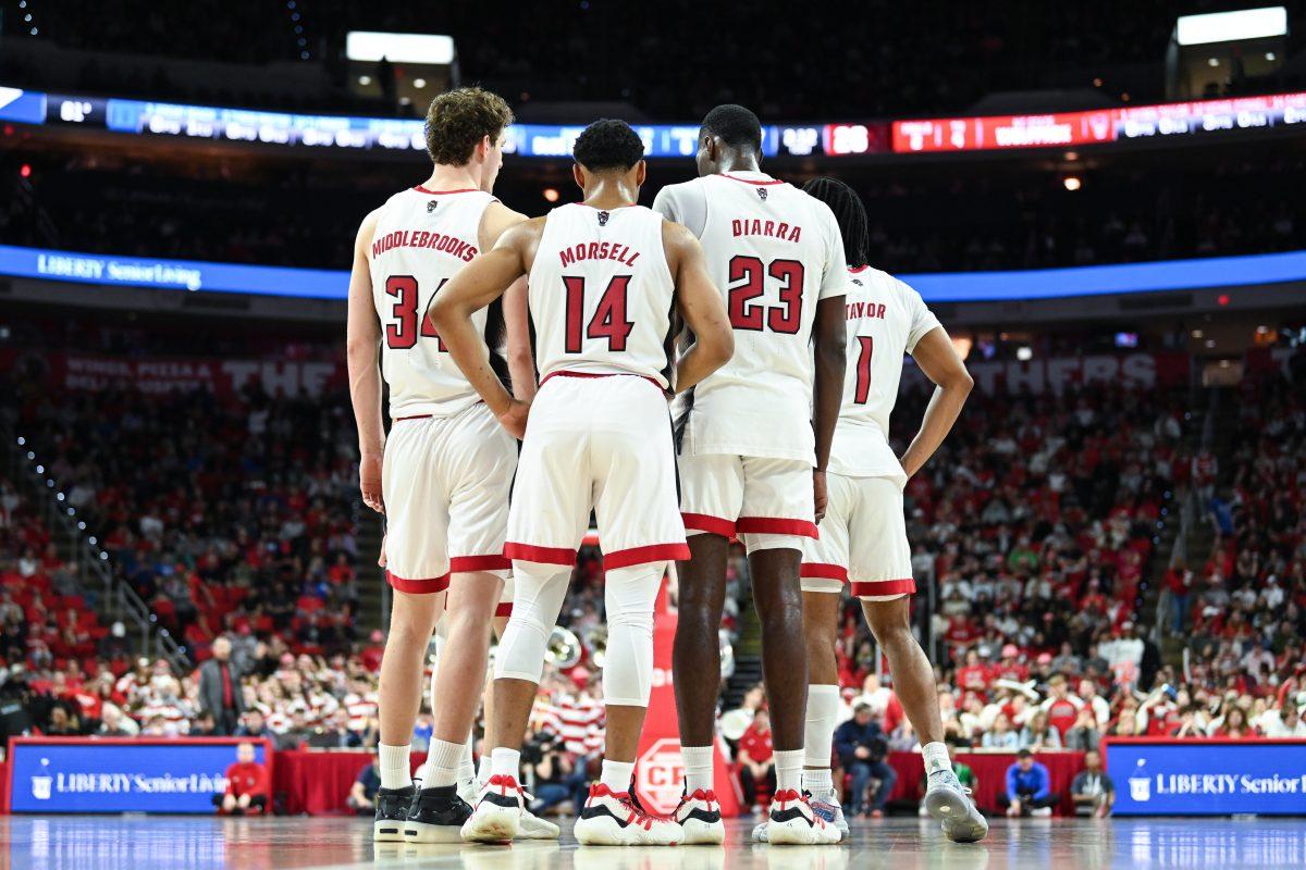 NC State huddles together during a timeout in the game against Duke in PNC Arena on Monday, March 4, 2024. NC State lost to Duke 79-64.