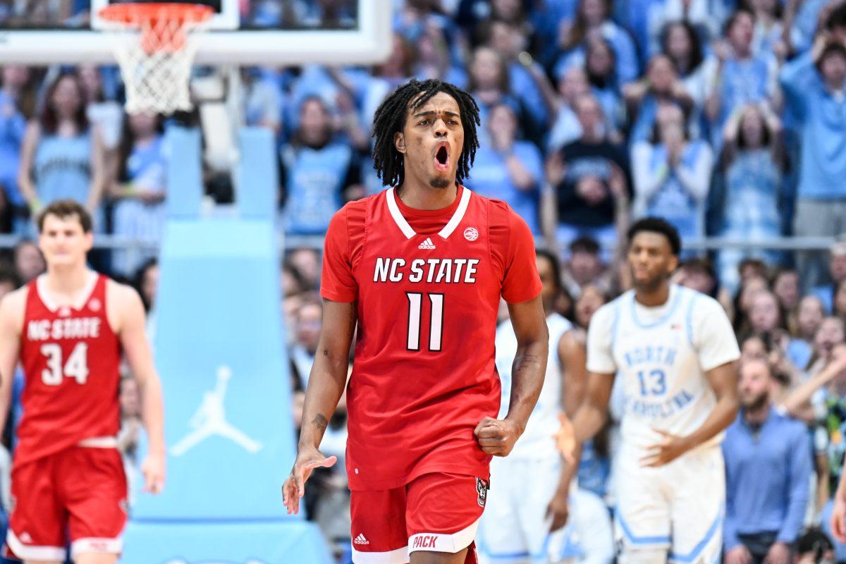Freshman guard Dennis Parker celebrates after scoring during the game against UNC-Chapel Hill in Dean E. Smith Center on Saturday, March 2, 2024. NC State lost to Chapel Hill 79-70.