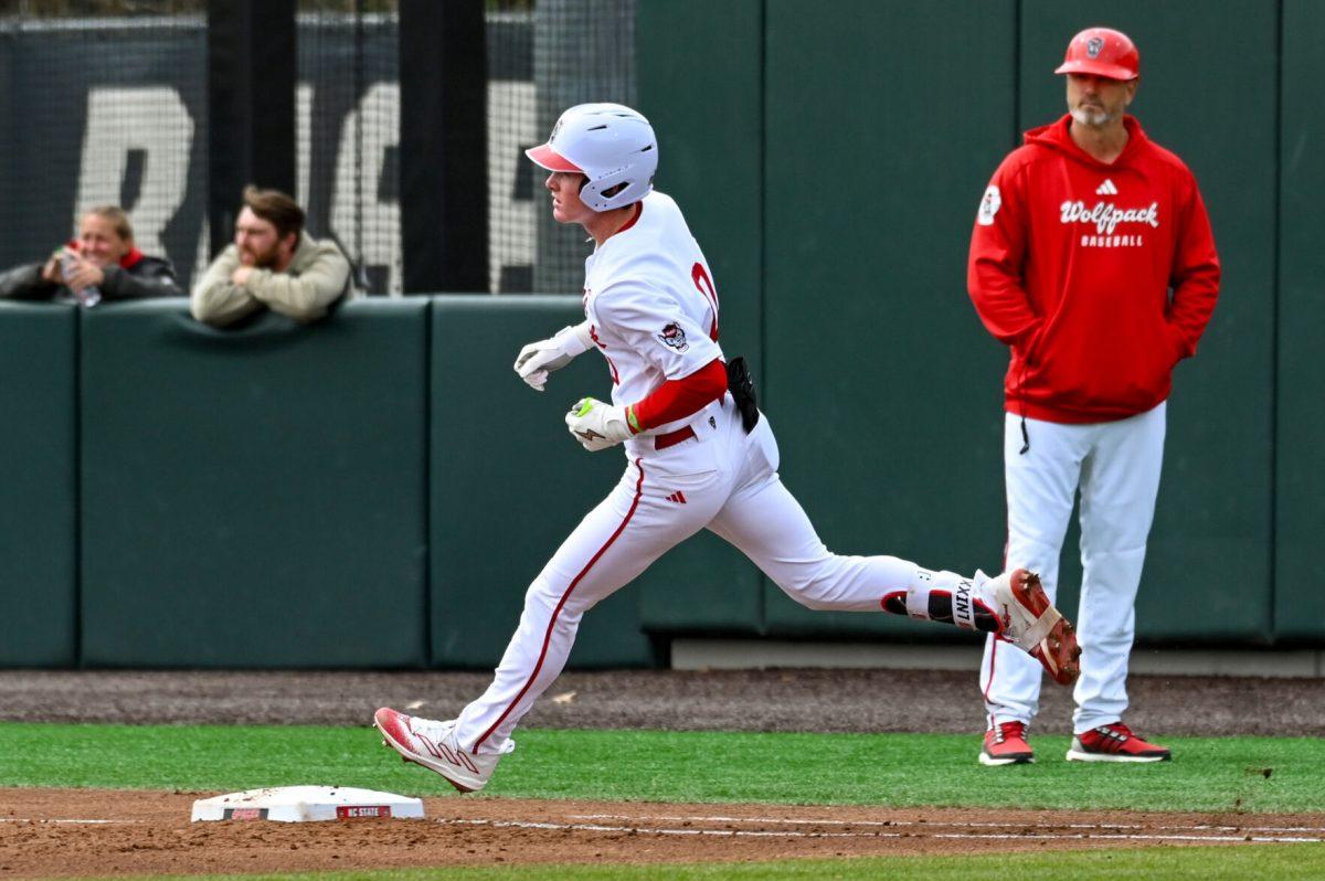 Freshman infielder Luke Nixon rounds first base during the baseball game against Towson at Doak Field at Dail Park on Friday, March 1, 2024. NC State beat Towson 6-5.