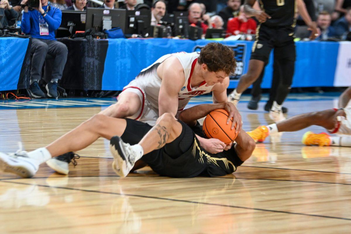 Junior forward Ben Middlebrooks fights for a loose ball during the NCAA March Madness round two game against the Oakland University Golden Grizzlies in PPG Paints Arena on Saturday, March 23, 2024. Middlebrooks had eight rebounds. The Wolfpack beat the Golden Grizzlies 79-73 in overtime.